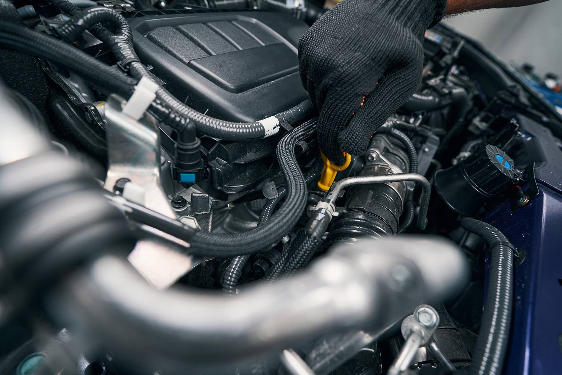Mechanic fixing car engine in garage.