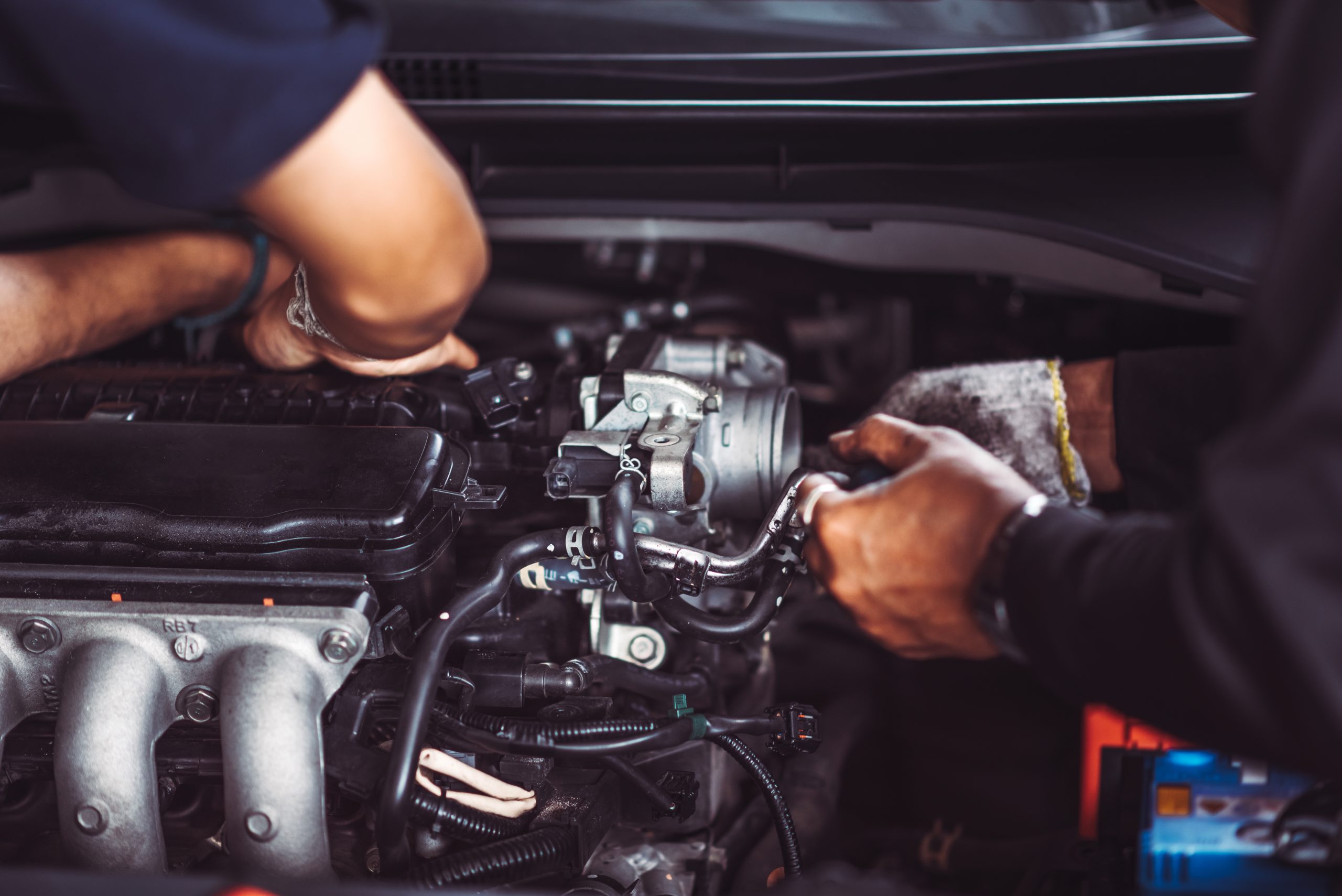 Close up photo of auto mechanic worker working in garage. Worksh